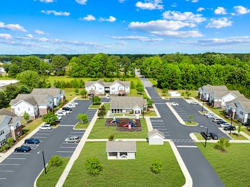 A suburban neighborhood with houses and parked cars.