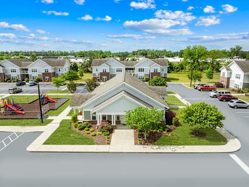 A view of a residential area with houses and a playground.