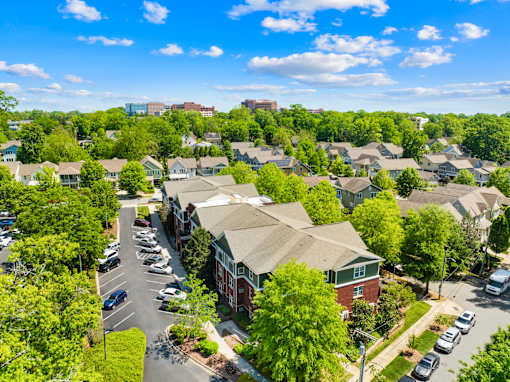 A suburban neighborhood with houses and parked cars.