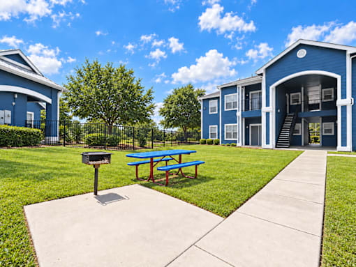 A blue building with a picnic table in front of it.