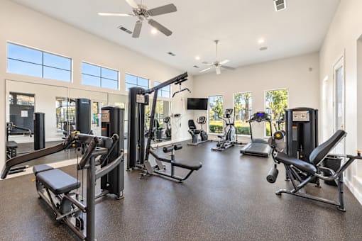 A spacious home gym with a variety of exercise equipment.