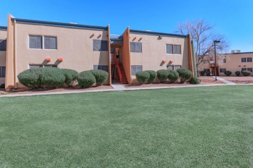 a lawn in front of an apartment building