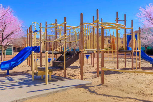 a playground with a blue slide and other playground equipment