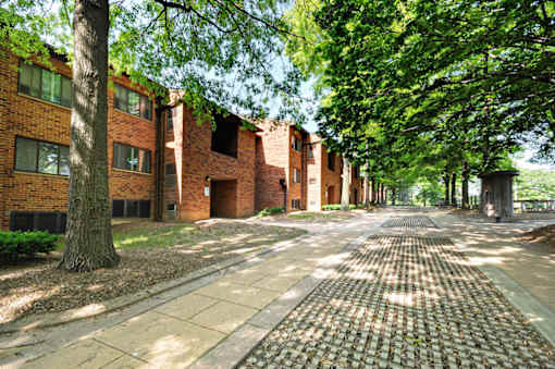 A brick building with a tree in front of it.