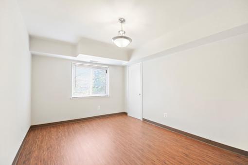Empty room with wooden floor and white walls.