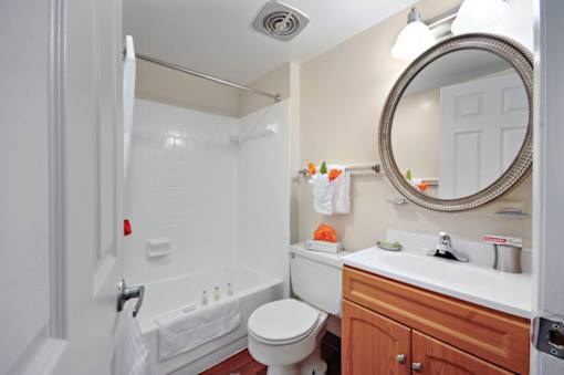 A bathroom with a toilet, sink, and shower.