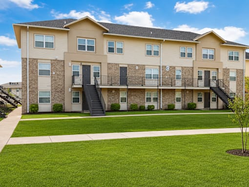 A large apartment building with a balcony on the second floor.