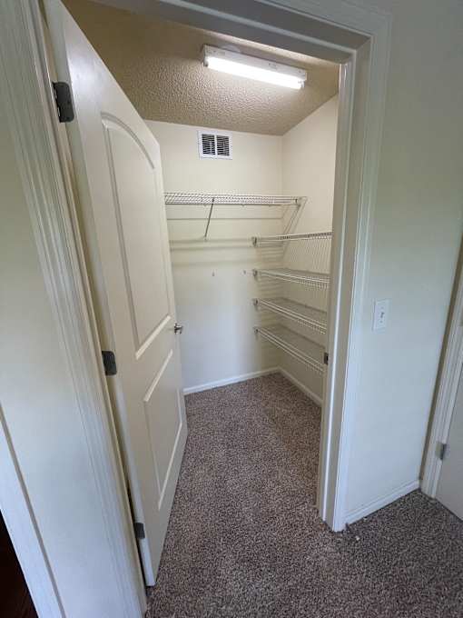 A white door with a handle is open.