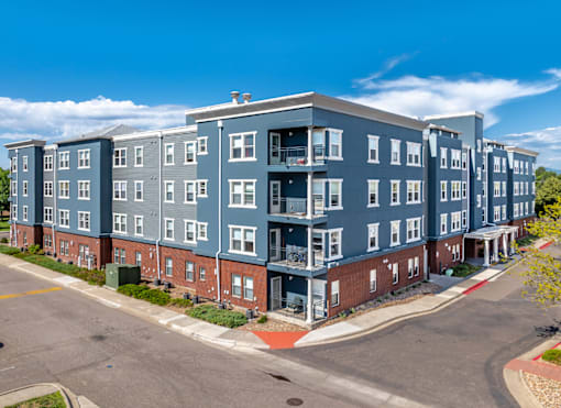 A large apartment complex with multiple buildings and balconies.