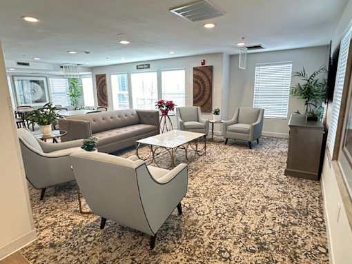 a living room with couches and chairs and a table