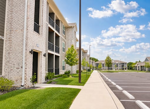 A sunny day at a residential complex with a clear blue sky.