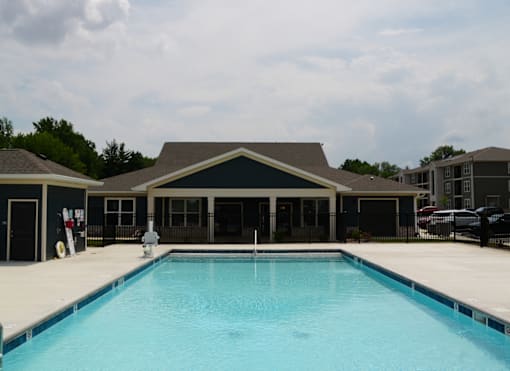A large swimming pool in front of a building.