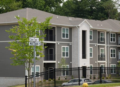 Apartment building with a sign that says "Clover Trail" and "Minute Mile".