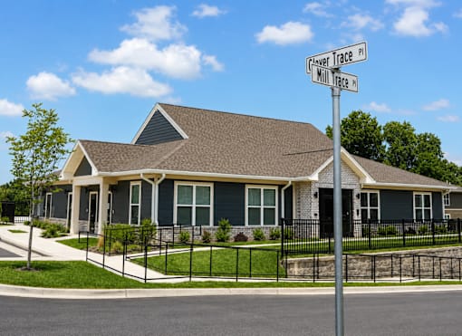 A house with a sign that says "Flower Trace" in front of it.