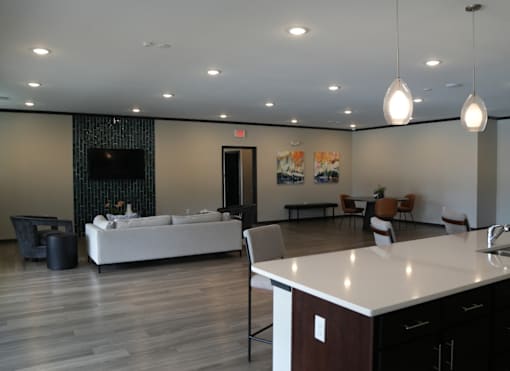 A modern living room with a white sofa and a television.