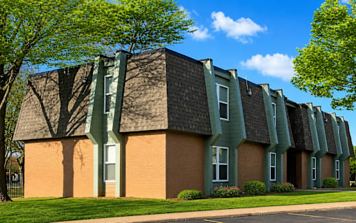 A building with a green roof and a brick facade.