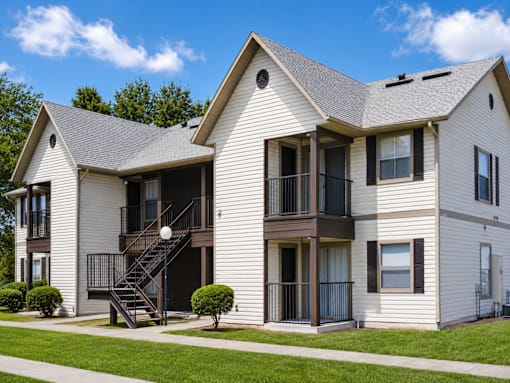 A two-story house with a balcony on the second floor.