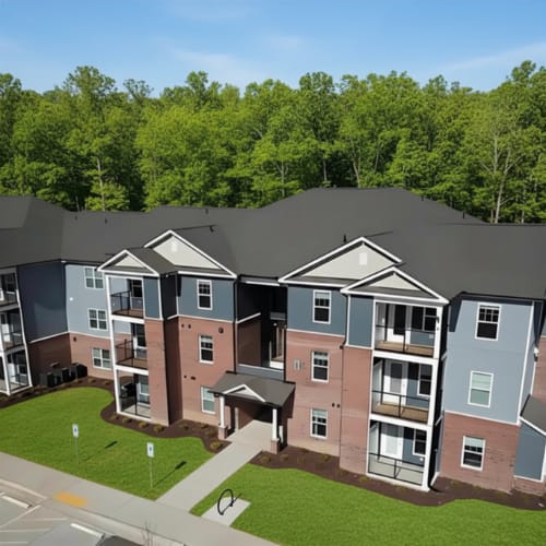 Apartment complex with multiple buildings and green lawns.