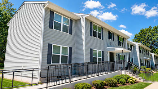 A grey house with black railings and windows.