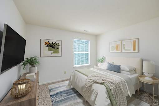 A bedroom with a bed, a nightstand, a lamp, a plant, and a painting on the wall.