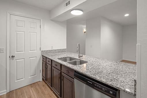 Kitchen with stainless steel appliances at Mammoth at the Orchard Apartments, Rogers