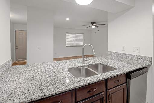 Kitchen with countertop and sink at Mammoth at the Orchard Apartments, Rogers, AR, 72756