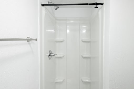 White bathroom with shower at Mammoth at the Orchard Apartments, Arkansas