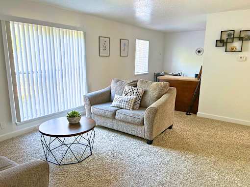 A living room with a couch, chair, and coffee table.