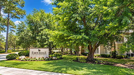 A sign that says Fawn Ridge Estates is in front of a building.