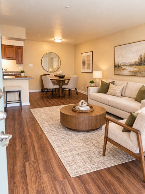 A modern living room with a wooden floor and furniture.