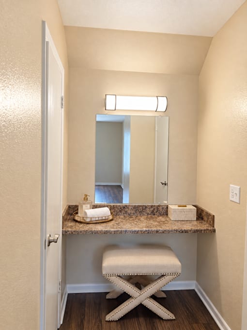 A bathroom with a vanity and a mirror.