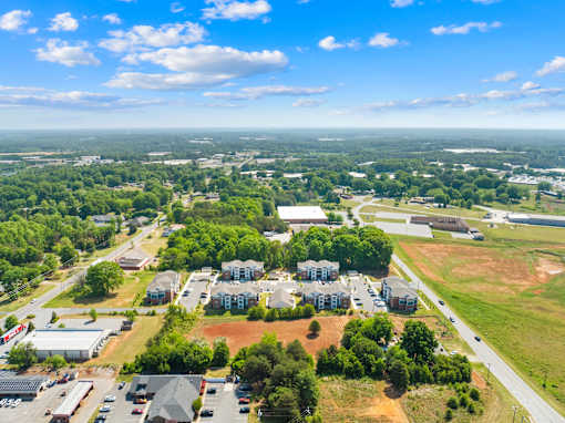 A bird's eye view of a residential area with houses and greenery.