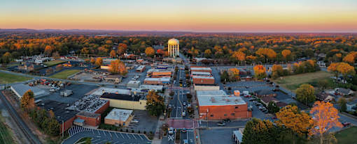 A view of a town with a large white dome structure in the center.