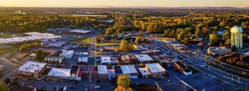 A small town with a large water tower in the distance.