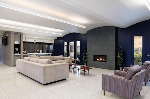 A modern living room with a fireplace and a large couch.