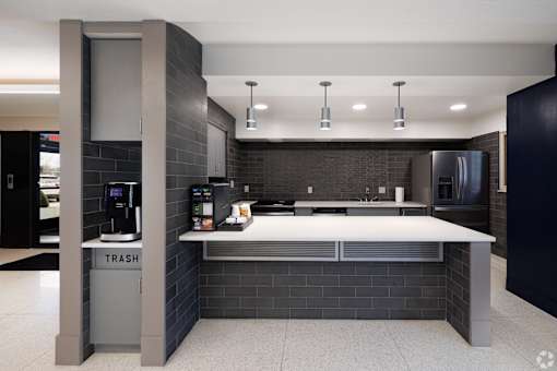 A modern kitchen with a trash bin labeled