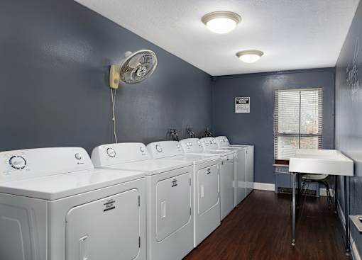 A laundry room with washers and dryers.