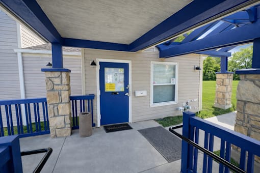 A blue door is on the left side of a house.