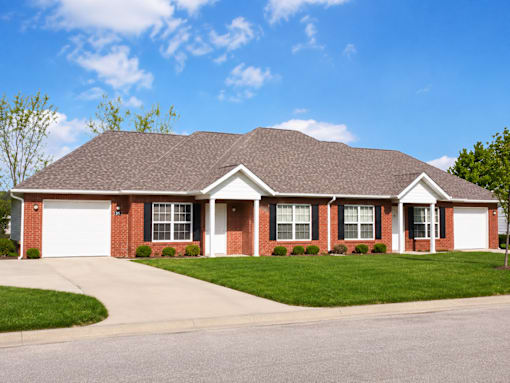 A red brick house with a white garage door.