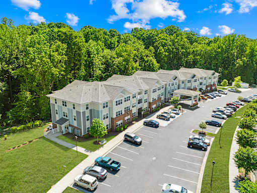 A large building with a parking lot in front of it.