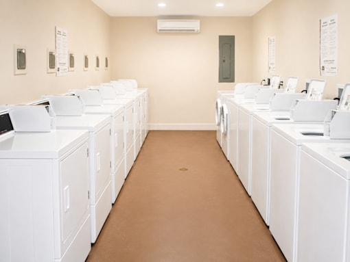 A laundromat with rows of washers and dryers.