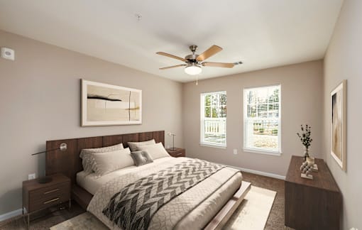 A bedroom with a large bed and a ceiling fan.