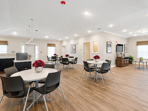 A dining room with a white table and chairs.