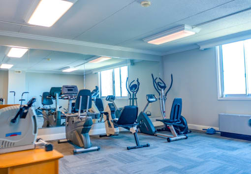 a room filled with lots of different types of cardio equipment