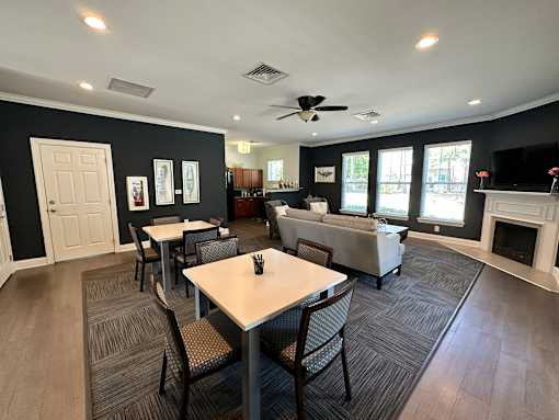 a living room with a table and chairs and a couch