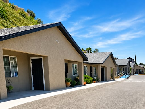 A row of houses with a hill in the background.