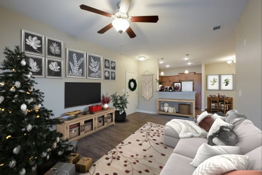 a living room with a christmas tree and a ceiling fan