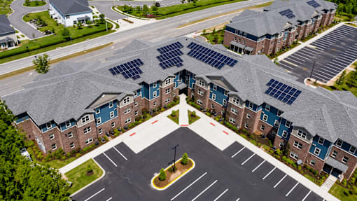 A large building with solar panels on the roof.