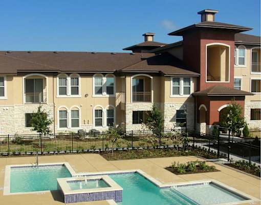 A large building with a pool in front.