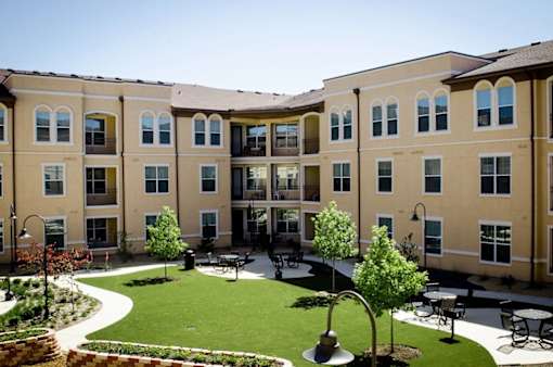 A large building with a courtyard in front of it.